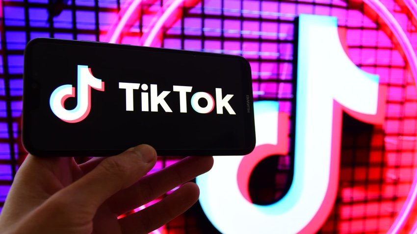 Photo illustration shows the TikTok logo displayed on a mobile phone screen.